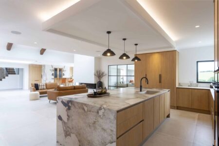 Verta oak kitchen with a veined waterfall island and black pendant lights