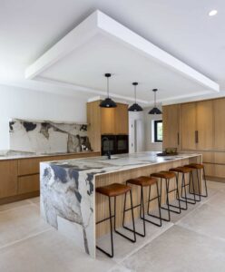 Angled view of the Verta island and full-height oak cupboards