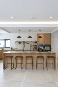 Front view of the Verta island, stools and cooking area