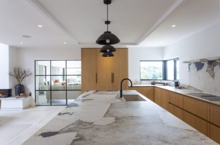 Verta island worktop and sink beneath black pendant lights
