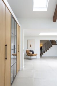 Full-height Verta oak cupboards alongside a bright hallway