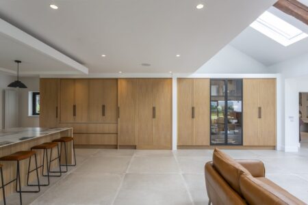 Wall of Verta oak cabinetry with a glazed display cupboard