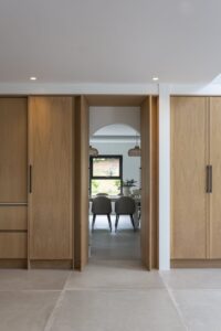 Open concealed doorway within Verta oak panelling