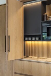 Illuminated Verta breakfast cupboard with ribbed oak backing