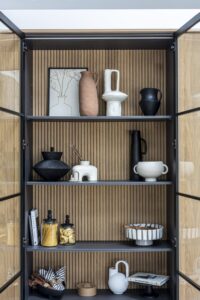 Close view of shelving and ribbed oak backing inside the Verta display cupboard