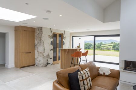 Open-plan living area with Verta oak home bar cabinetry