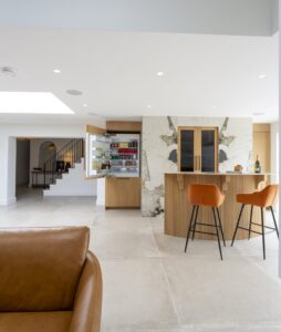Verta home bar with open storage and orange stools